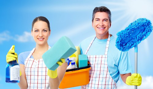 Upholstery cleaning equipment preparing a fabric sofa