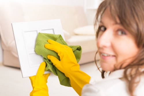 A cleaner vacuuming floors during a regular cleaning visit in Croydon
